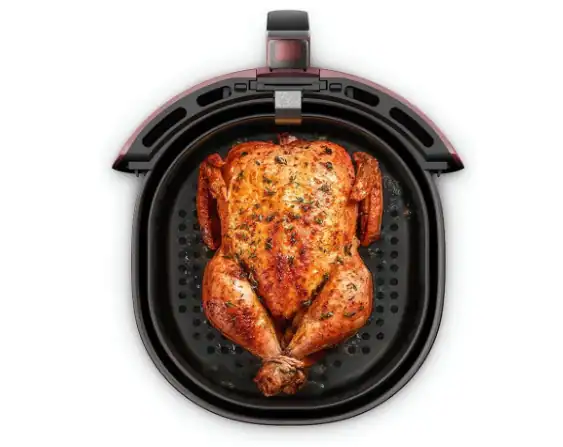 Frango inteiro assado e dourado dentro do cesto quadrado antiaderente da Air Fryer Electrolux de 5 litros